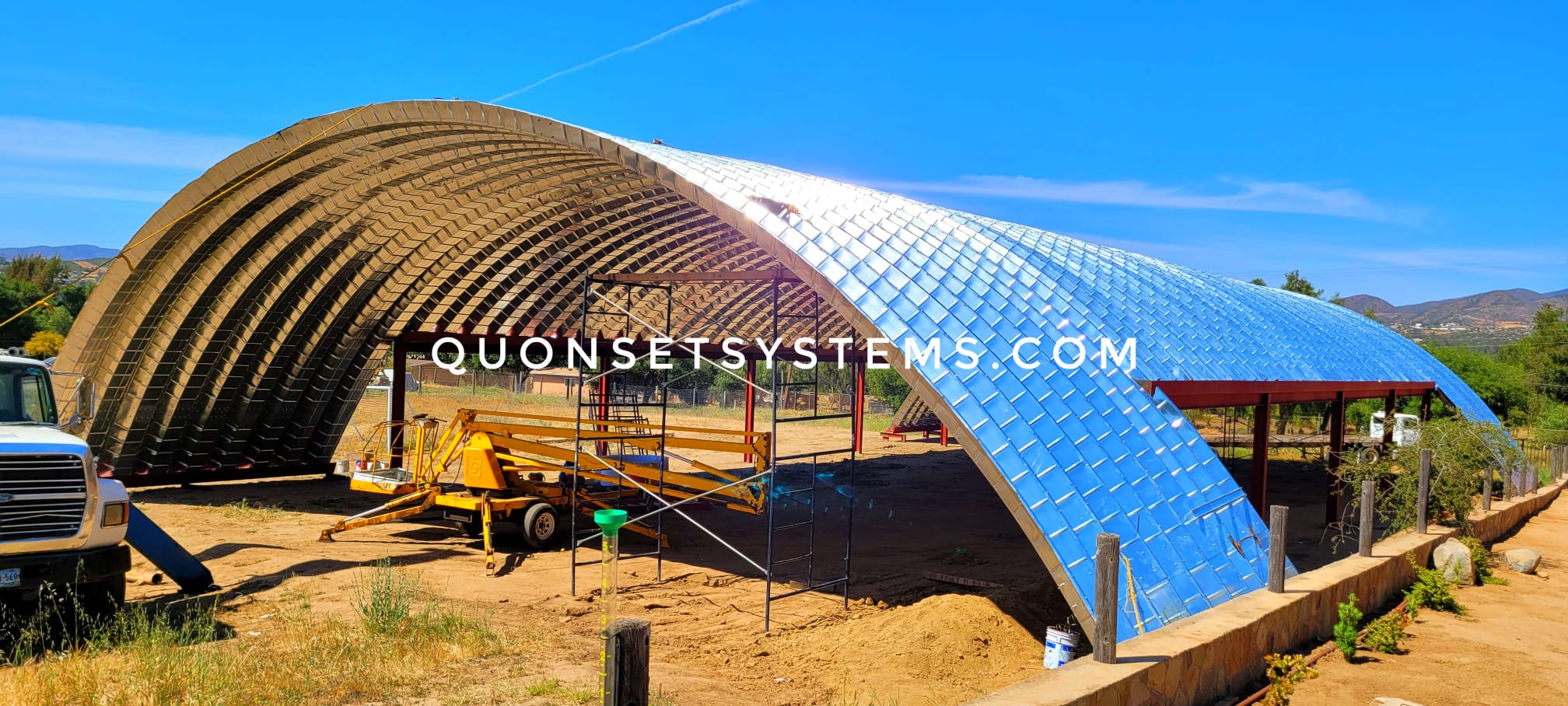 Crane installing corrugated arch structure for an industrial building in Tijuana